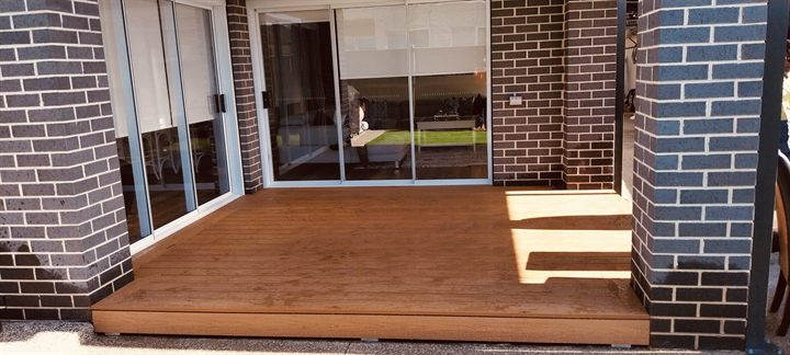 Completed decking area outside a brick home