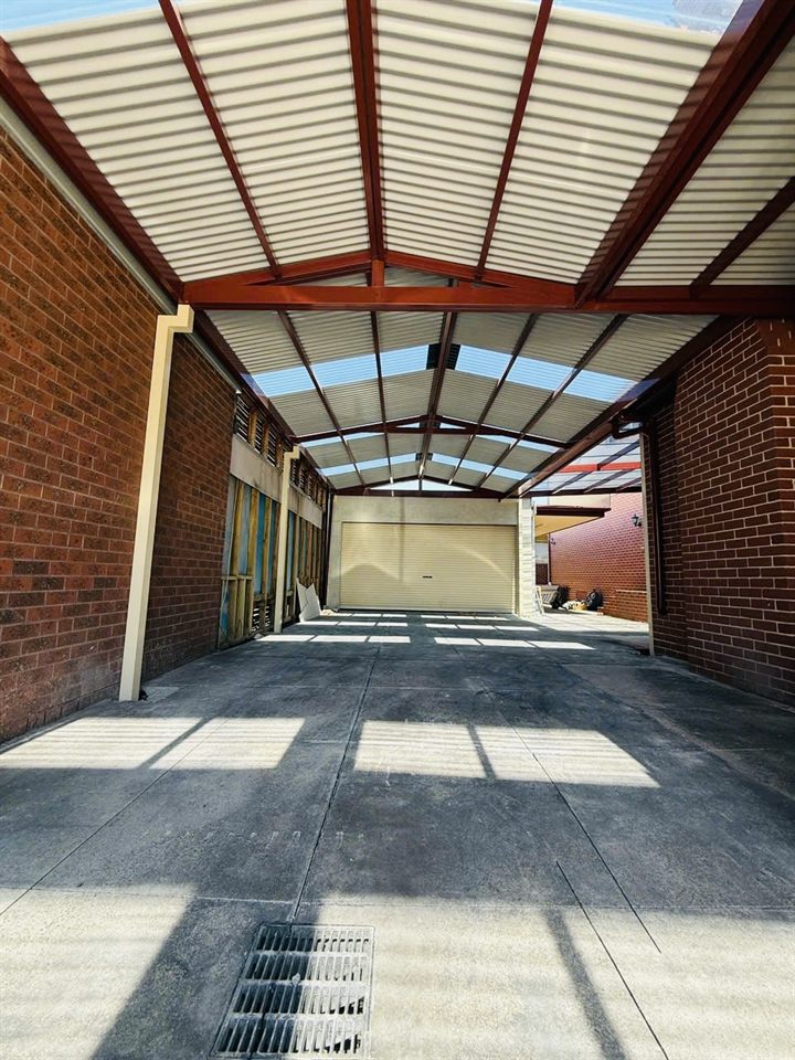 Covered verandah structure between brick walls